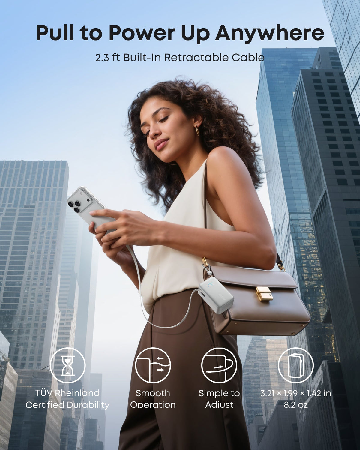 Anker portable power bank with retractable cable for city charging.